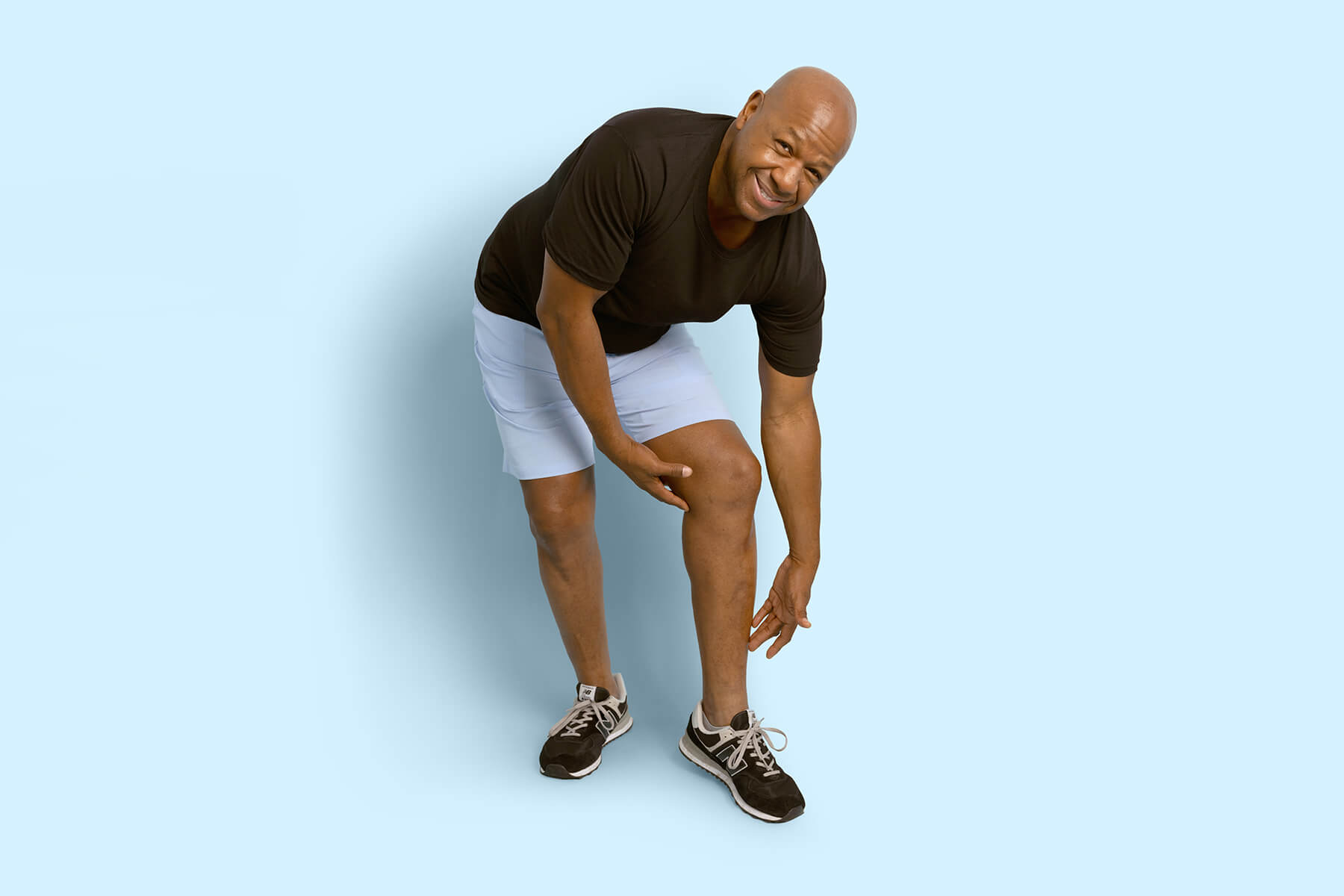 Man holding his leg because of leg pain